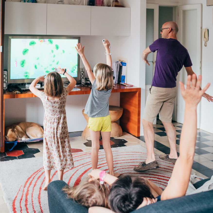 Family dancing together indoor playing videogame - healthy lifestyle, togetherness, playing concept