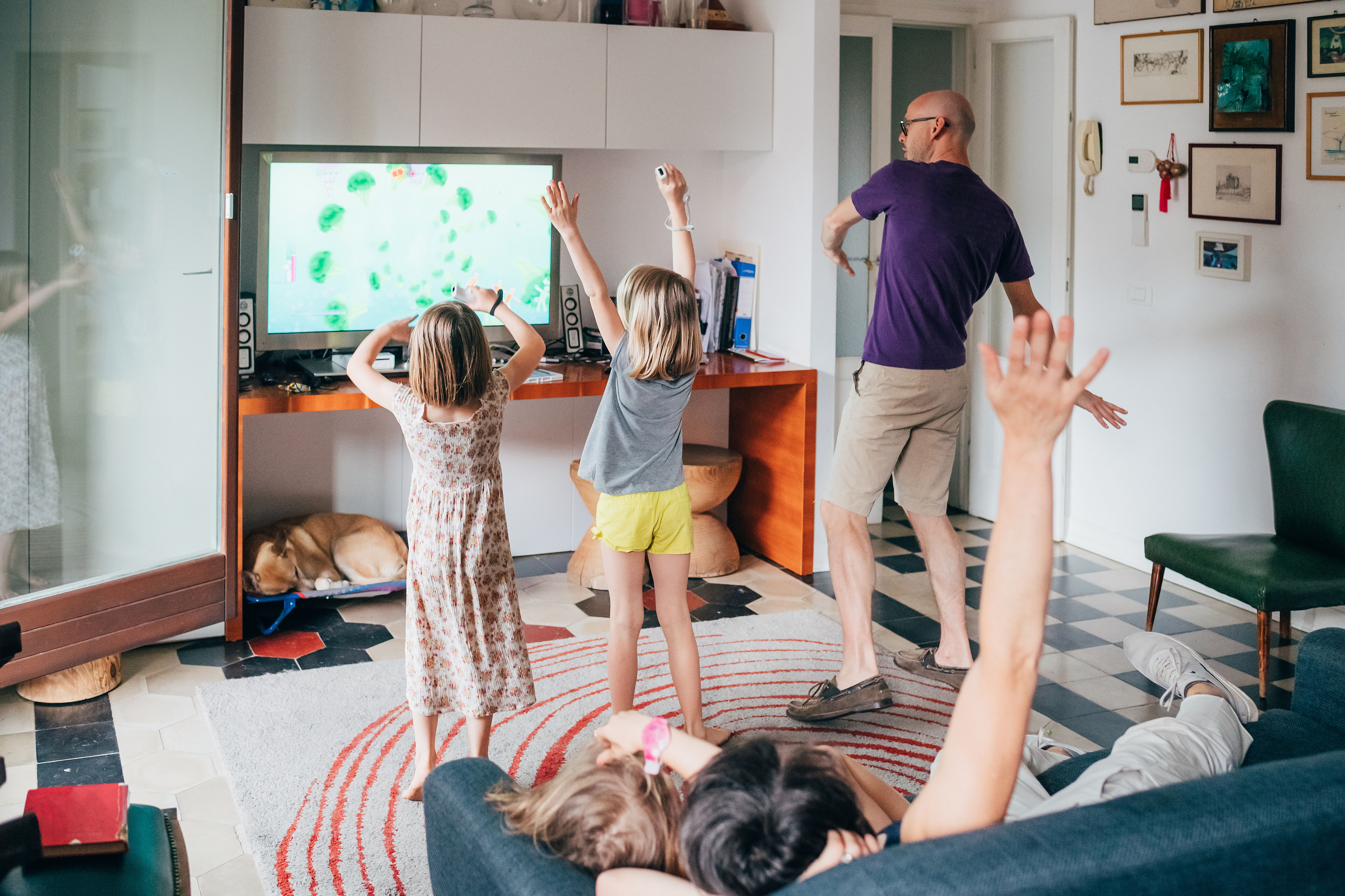 Family dancing together indoor playing videogame - healthy lifestyle, togetherness, playing concept